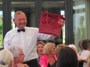 Trustee Neville Dippie holding one of the donated bags being auctioned at the Trust's "Old Bag's Lunch" fundraiser